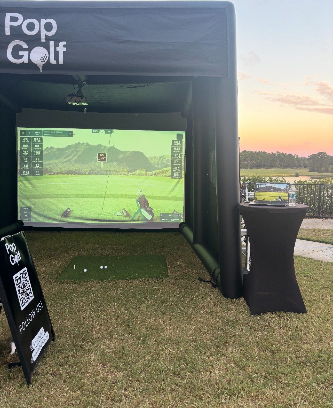 PopGolf simulator set up on the tee deck of a private golf club at sunset