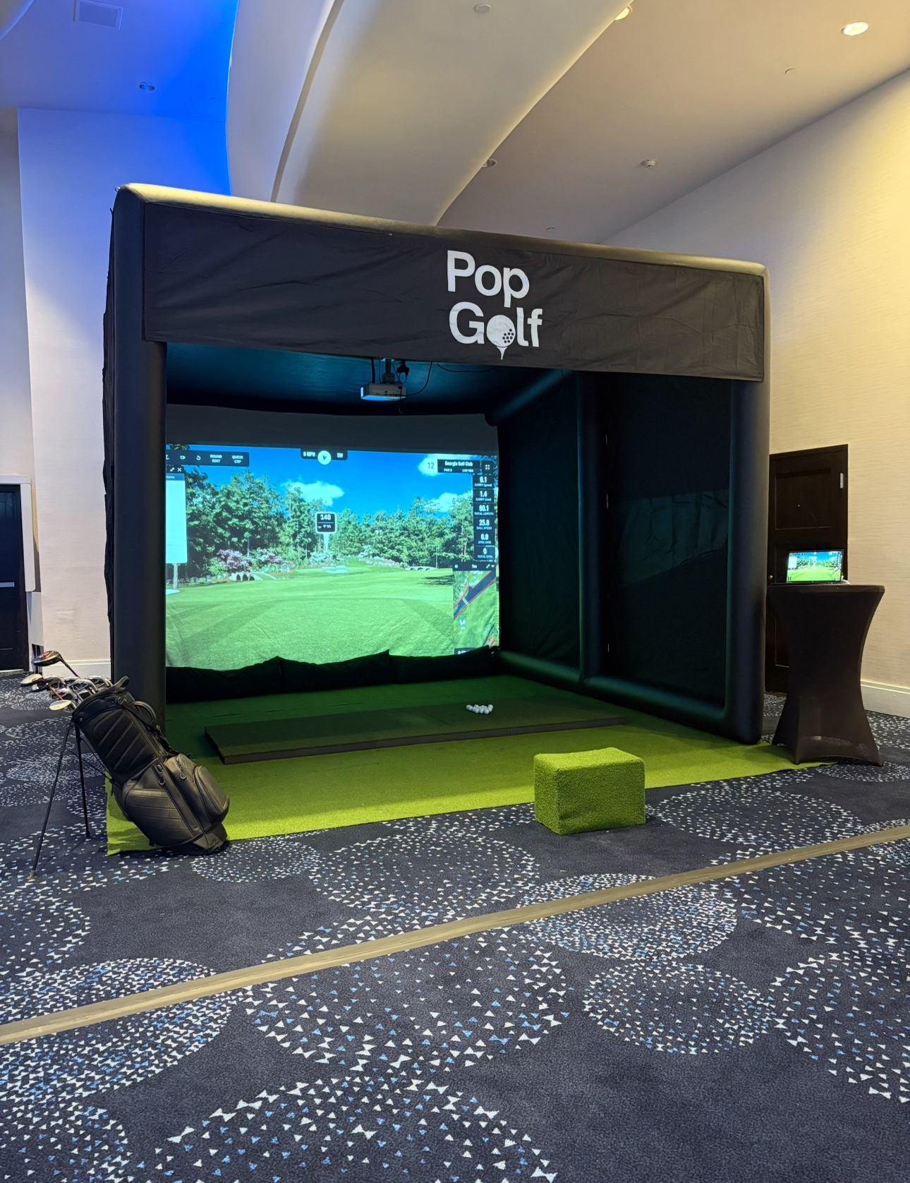PopGolf simulator setup inside a hotel ballroom